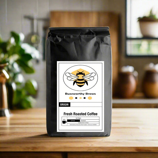 Bag of Buzzworthy Brews Colombian Medium Roast Coffee, featuring dried orange, berry, and chocolate flavors. Sourced from smallholder farmers in Medellin, Colombia.